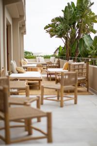 a group of chairs and tables on a balcony at Boutique Apartments Marsol Ibiza in Santa Eularia des Riu