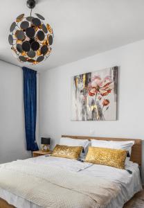 a bedroom with a large bed and a chandelier at Romeo&Julia- luxurious apartment by the sea in Pomer
