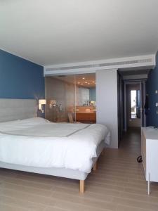 a bedroom with a large white bed and a bathroom at Higueron 3 bed/2bath modern flat in Fuengirola
