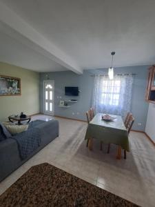 a living room with a couch and a table at Vila Flor in Lajes das Flores