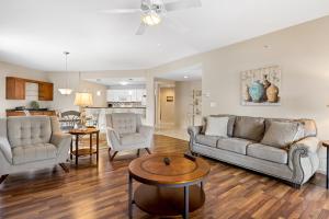 a living room with two couches and a table at Regatta Retreat in Lake Ozark