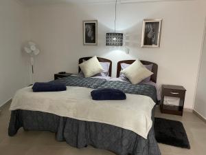 a bedroom with a large bed with two pillows on it at Departamento Merced in Quillota