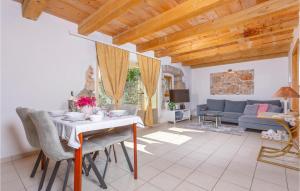 a living room with a table and a couch at Nice Home In Krk With Outdoor Swimming Pool in Garica