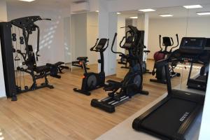 a gym with several treadmills and exercise bikes at Hotel Marfil in San Antonio