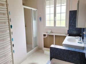 a bathroom with a sink and a shower at Casateja Houlgate in Houlgate +15 photos