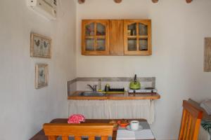 a small kitchen with a sink and a table at Monoambiente Golondrina in Capilla del Monte