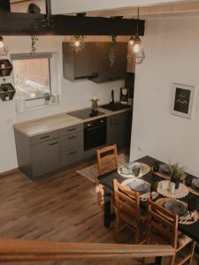 a kitchen and dining room with a table and chairs at HomyHouse in Sibiu