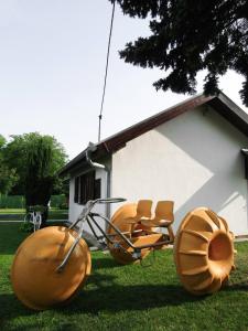 a group of spheres sitting in the grass in front of a house at OBALA apartman in Subotica