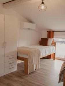 a bedroom with a bed and a dresser and a window at HomyHouse in Sibiu