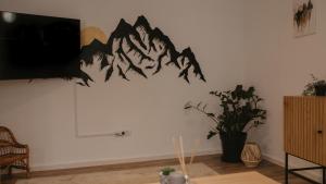 a wall with a painting of mountains on it at HomyHouse in Sibiu