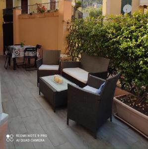 a patio with chairs and a table on a building at La casa dei gelsomini in Alassio