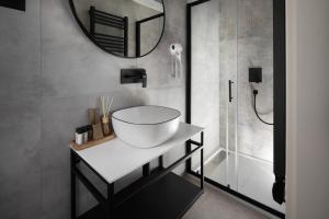 a bathroom with a sink and a mirror at Arena Prestige Rooms in Pula