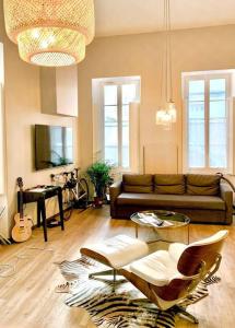 a living room with a couch and a table at Charming apartment in the Chartrons district in Bordeaux