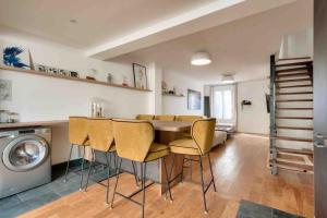 a kitchen and dining room with a table and chairs at House near Paris/Stade de France in Saint-Denis
