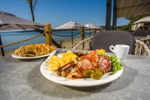 two plates of food sitting on a table at Olive Villas Beach Hotel in Sozopol