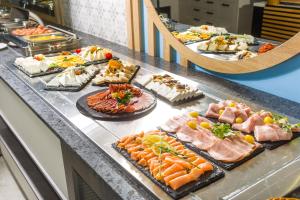 a buffet line with many different types of food at Olive Villas Beach Hotel in Sozopol