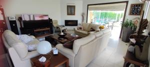 a living room with white couches and a tv at Bahía 66 in Empuriabrava
