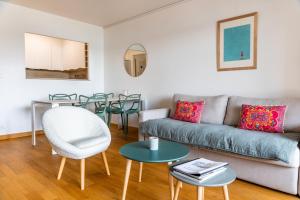 a living room with a couch and a table at SUNSHINE - Appartement 2pers - terrasse vue mer - Dinard in Dinard