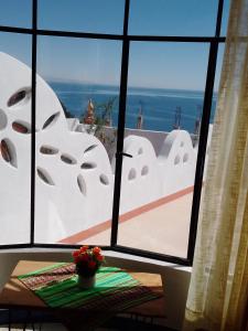 a window with a view of the ocean from a house at Jardín Andino hostal in Copacabana