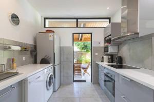 a kitchen with a refrigerator and a dishwasher at Villa Saline in La Saline les Bains