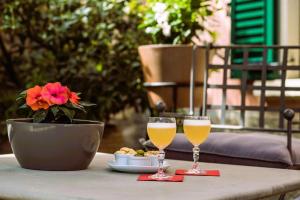 two glasses of wine and a plate of food on a table at La Valletta Relais in Bergamo