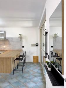 a kitchen with a counter and stools at Casa Vacanze Maride in Capitana
