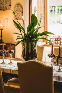 a table with a vase with a plant on it at La Valletta Relais in Bergamo