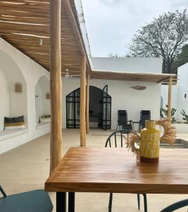 a wooden table with a vase on top of a patio at Las Guapas Villas Tamarindo in Tamarindo