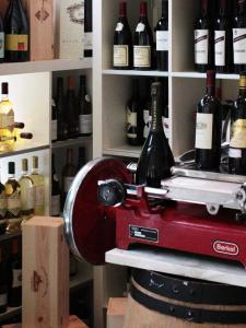 a bottle of wine is being poured into a machine at Hotel La Pigna in Marina di Pietrasanta