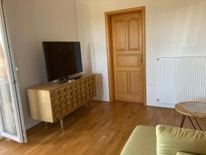 a living room with a flat screen tv on a dresser at Apartment Anabella in Fažana