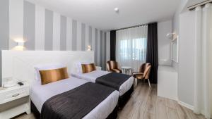 Кровать или кровати в номере Motto Premium Hotel&Spa