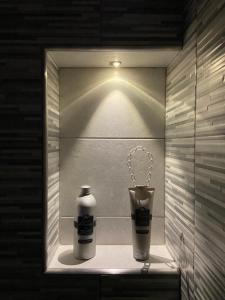 a shelf with a bottle and a cup in a bathroom at Casa di Nonna Gilda in Massa Lubrense