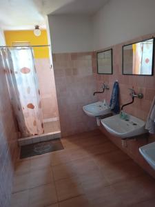 a bathroom with two sinks and a shower at Turistika ubytovňa sivá brada in Spišské Podhradie +78 photos