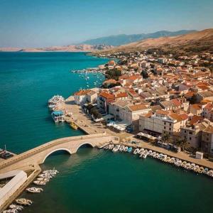 an aerial view of a town with a bridge over the water at Rooms & studio OLD TOWN PAG in Pag