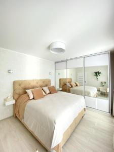 ブラチスラヴァにあるDie Eleganz - Exclusive Apartment near the City Centerのベッドルーム(大型ベッド1台、鏡付)