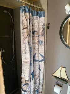 uma cortina de chuveiro na casa de banho ao lado de um chuveiro em Seaside holiday home Vecvalki em Saunags