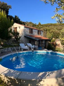 a large swimming pool in front of a house at konoba in Rab