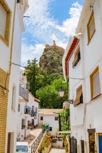 a view of a mountain from between two buildings at Apartamento Horno Castril in Castril