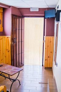 a room with a table and a large window at Apartamento Horno Castril in Castril