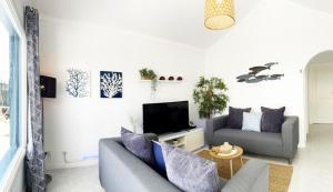 a living room with a couch and a tv at Caserones 04 in Puerto del Carmen
