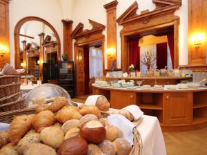 uma pilha de pães e bolos sobre uma mesa em Hotel Schweizerhof Sta Maria em Sta Maria Val Müstair