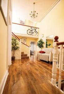 a living room with a couch and wooden floors at Truro Central Studios in Truro