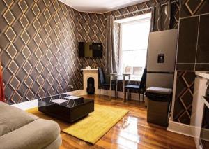 a living room with a couch and a fireplace at Truro Central Studios in Truro