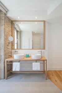two sinks in a bathroom with a mirror at Porto Real Hotel in Finisterre