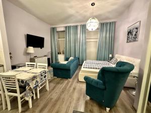 a living room with a couch and a table at Kings main square Apartment - AC - Balcony - Coffee Machine - Washer - Kitchen- Parking in Poprad +23 photos
