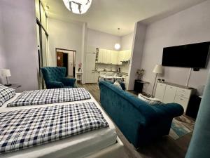 a living room with two beds and a couch at Kings main square Apartment - AC - Balcony - Coffee Machine - Washer - Kitchen- Parking in Poprad