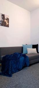 a bed with a blue blanket on the floor in a room at Prywatny pokój dla dwóch osób. Centrum. Pokój 5 in Warsaw