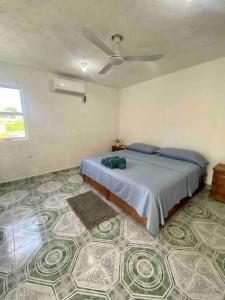 a bedroom with a bed with a ceiling fan at Apartment located two blocks from the sea in Cozumel