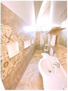 a bathroom with two toilets and a sink at Casa Vacanze Patrizia in Botrugno
