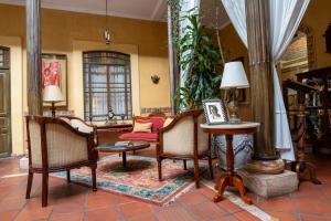 a living room with chairs and a table at Mansion Alcazar in Cuenca